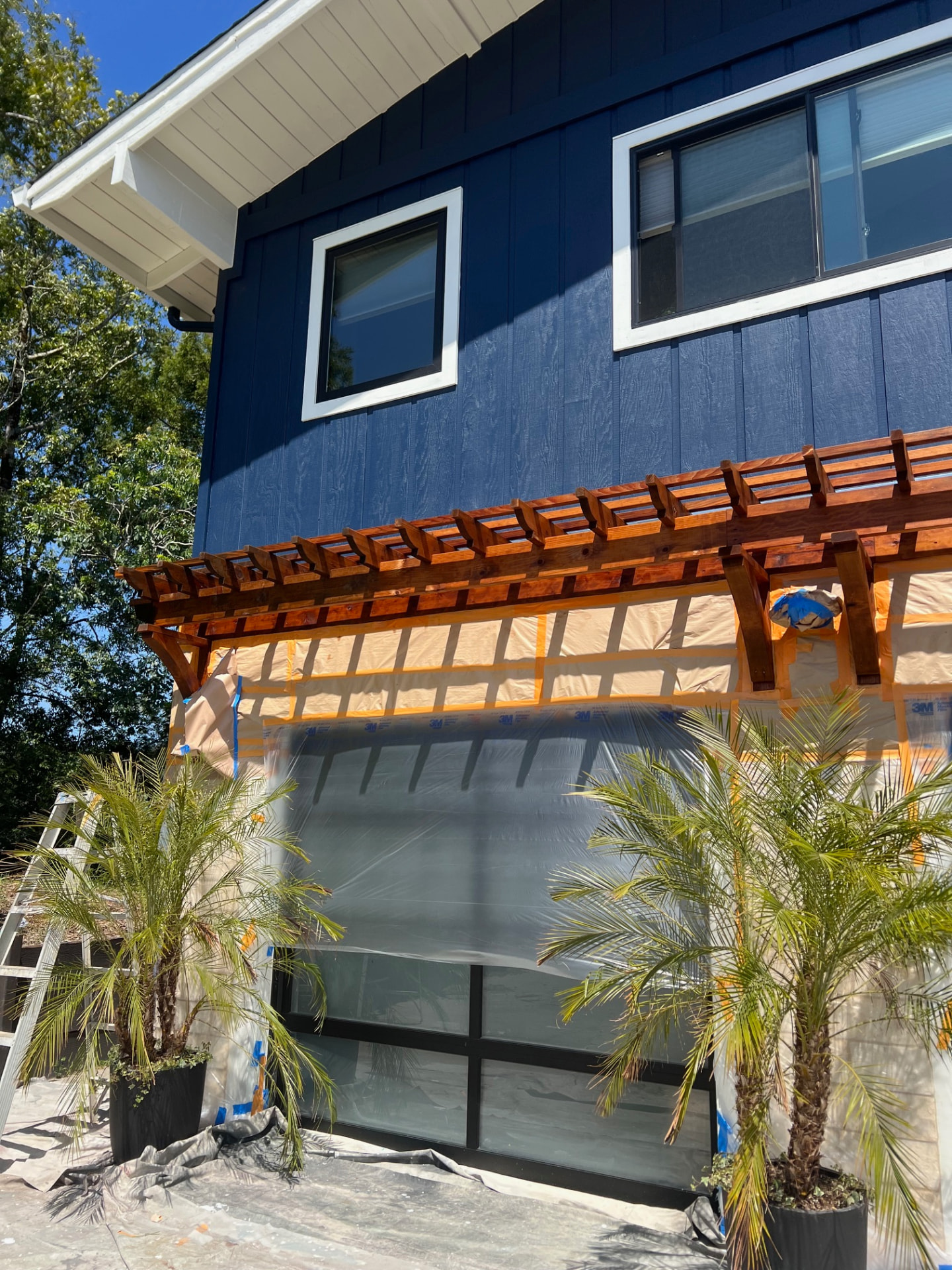 Completed navy exterior with stained pergola and stone accents