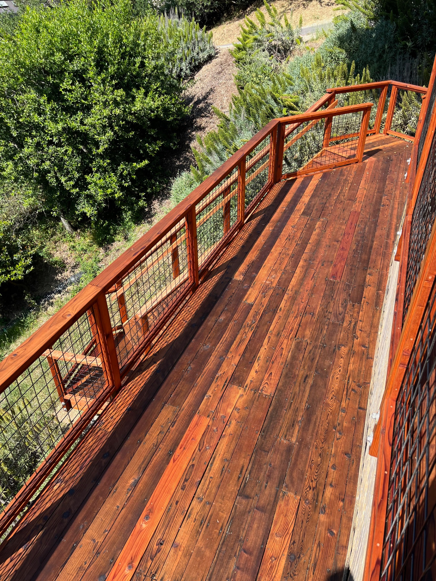 Long deck walkway with newly stained railing
