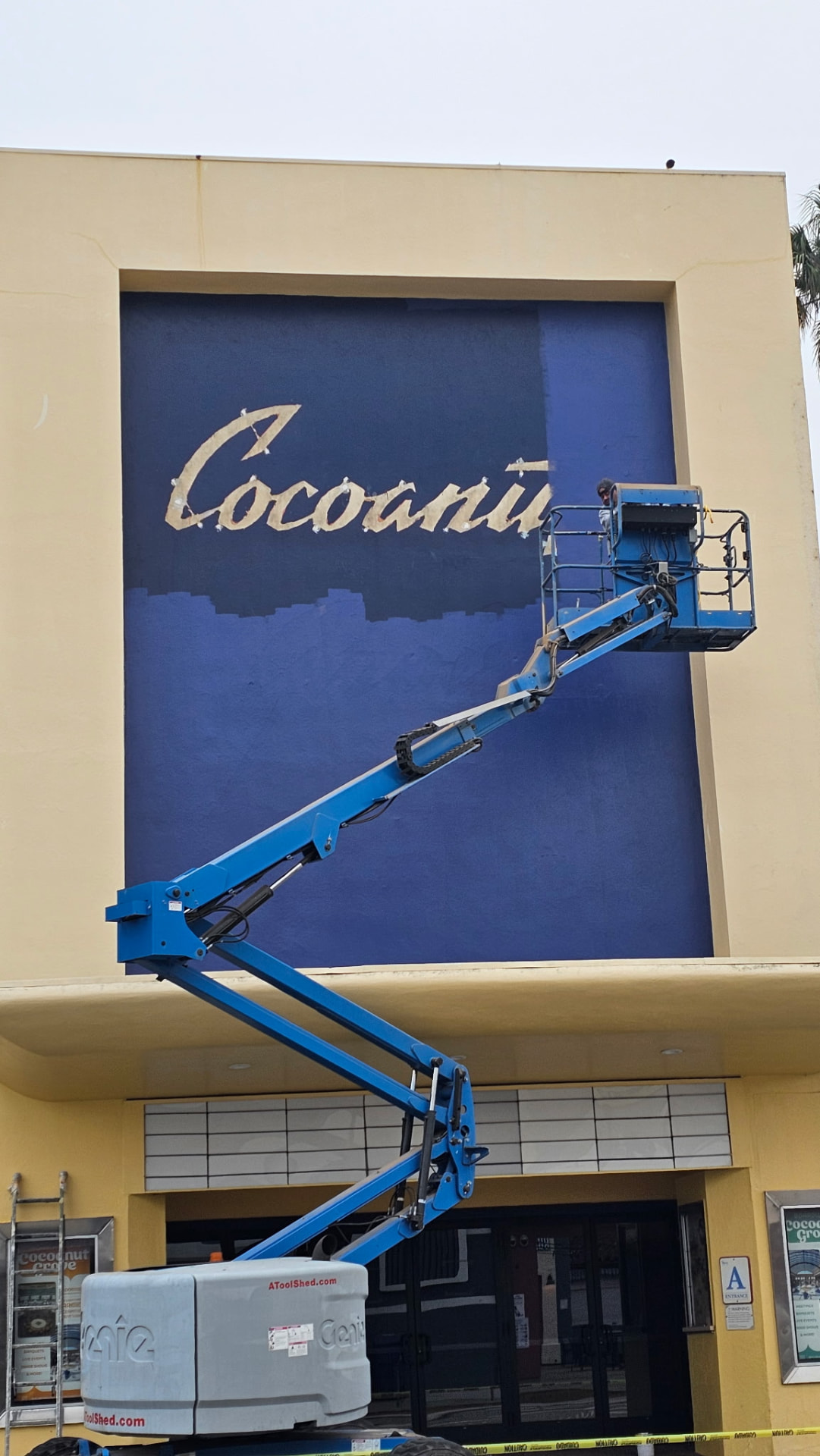 Repainting the navy panel behind the Cocoanut Grove lettering