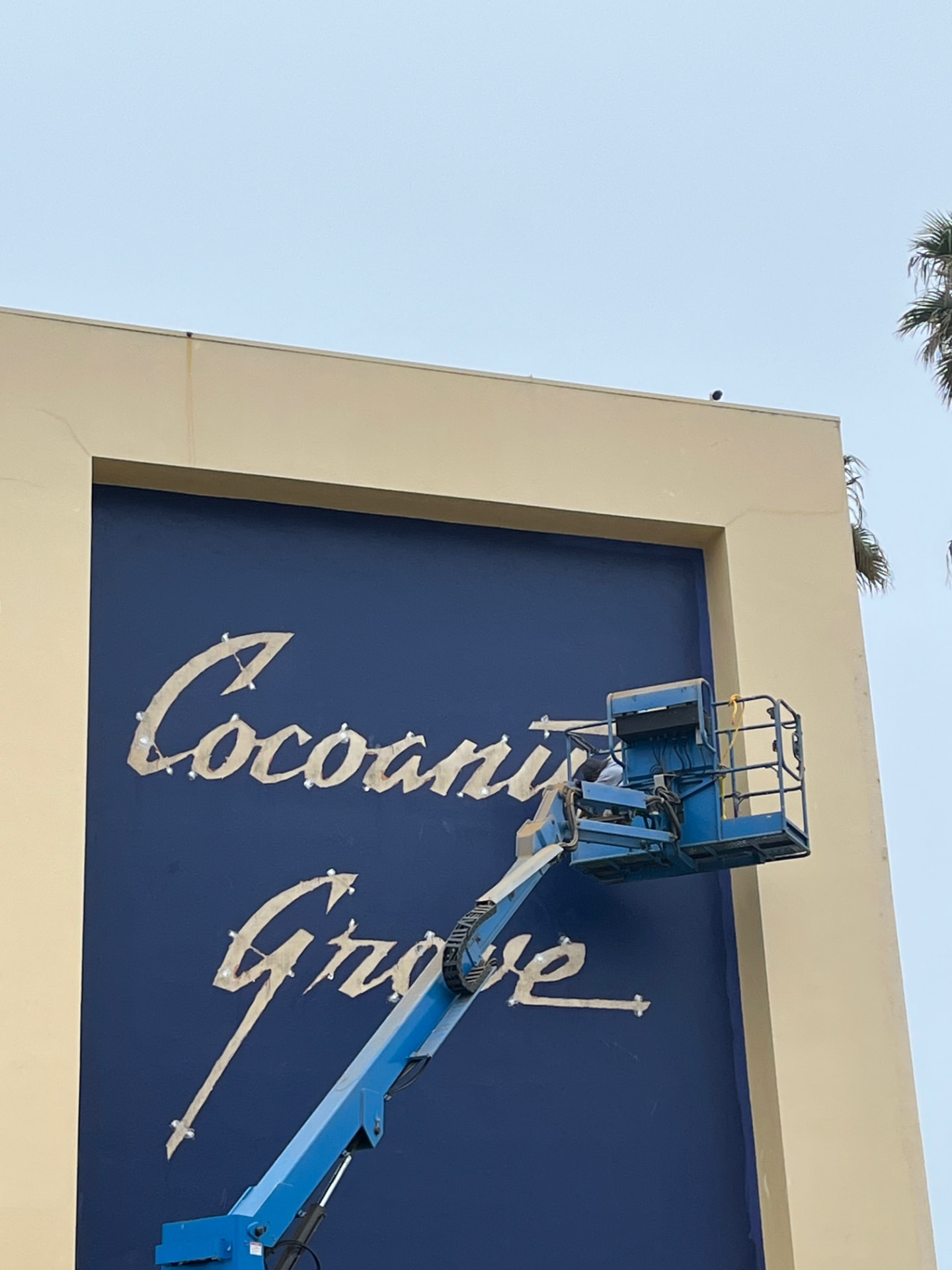 Painting around the historic Cocoanut Grove sign