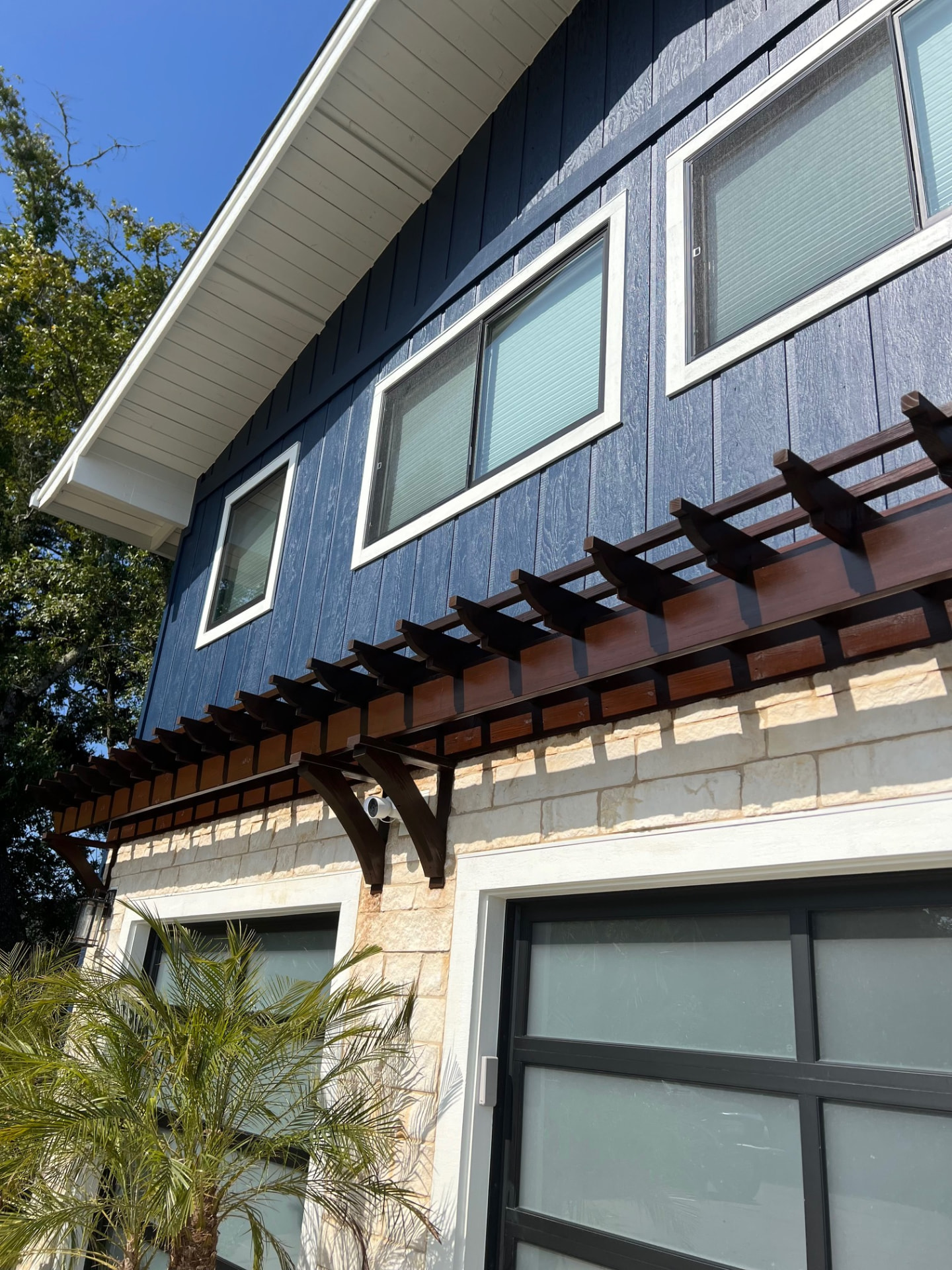 Repainted navy siding with crisp white window trim
